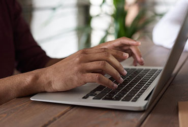 Mobile Pharmacy Request Form person using macbook